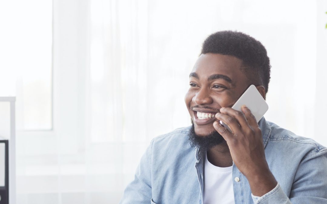 Happy office worker received good news on phone